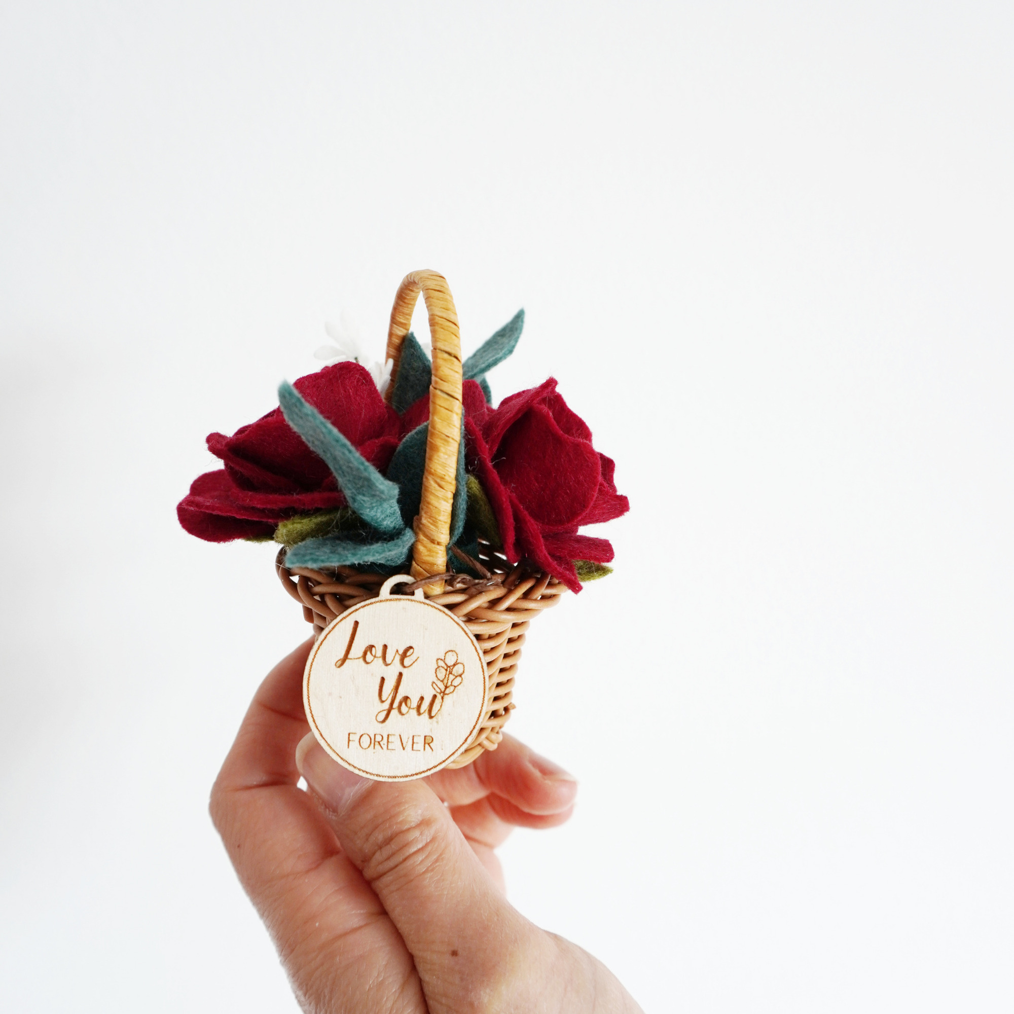 Tiny roses in basket with wooden tag